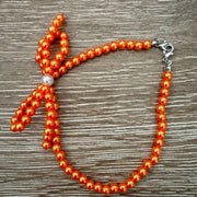 On A Whim Hats Orange Pearl Bow Beaded Bracelet
