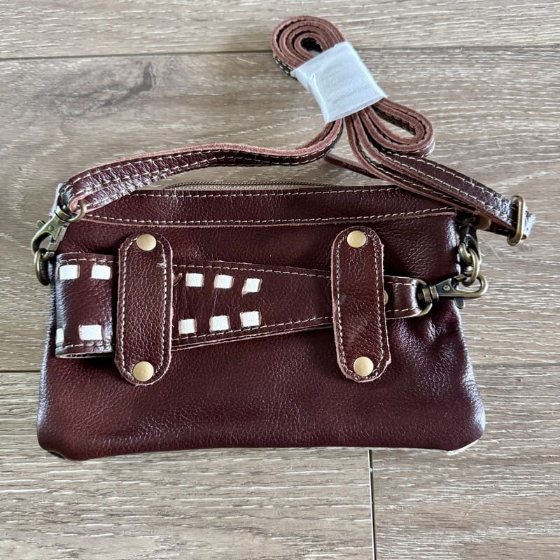 Honey cowhide Western handbag with leather trim and adjustable strap, worn crossbody or belt bag