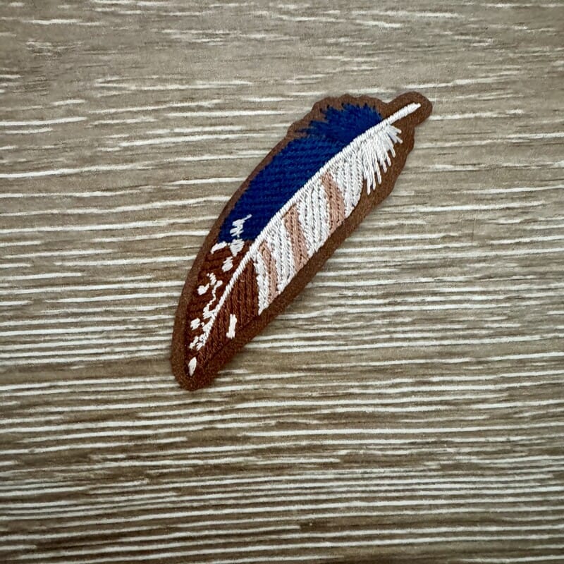 Boho feather embroidered iron-on patch in blue, white and tan with dot details