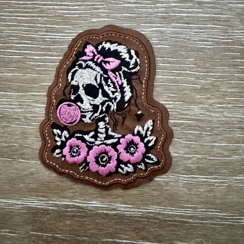 Skeleton cowgirl blowing bubblegum floral iron-on patch