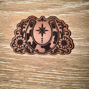 Cow print horseshoe and sunflowers laser-engraved leather-look iron-on patch with north star and scrollwork by On A Whim Hats
