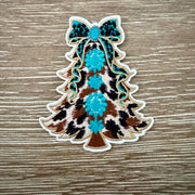 Cow print Christmas tree iron-on patch with turquoise floral medallions and a sparkly bow topper by On A Whim Hats
