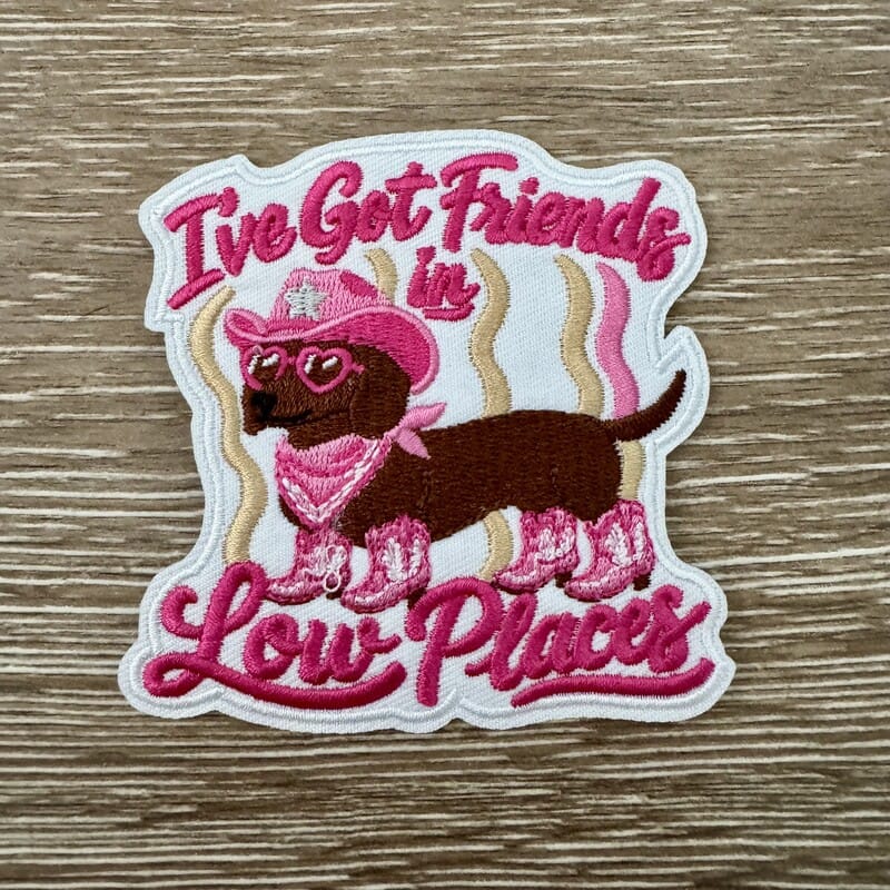 Cowgirl Doxie iron-on patch with a dachshund in a pink cowboy hat, bandana and boots plus country saying by On A Whim Hats