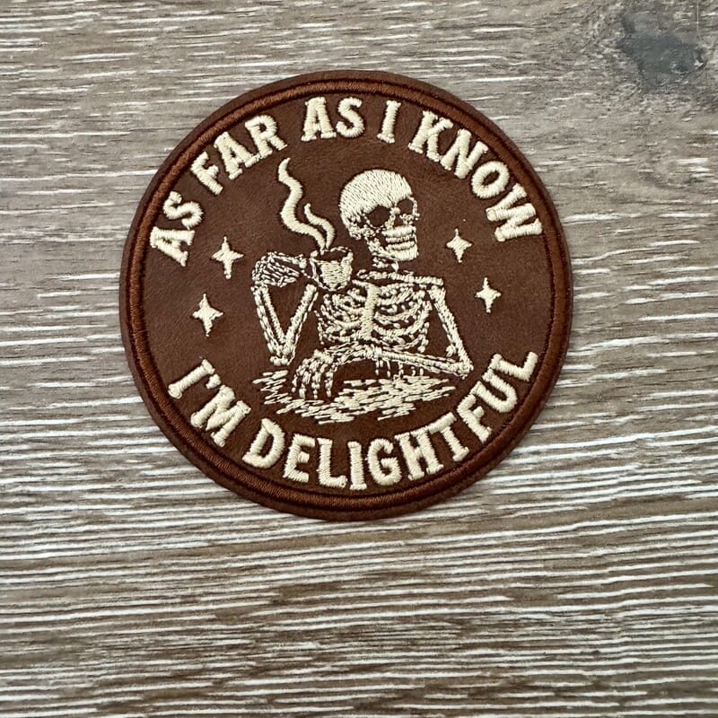 Round brown Delightful Skeleton Coffee leather iron-on patch with embroidered skeleton sipping coffee for hats