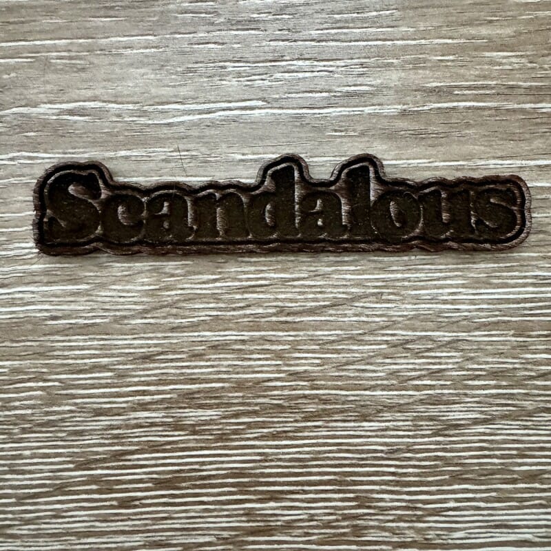 On A Whim Hats Scandalous Wood-Tone Iron-On Patch