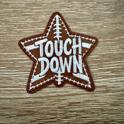 Star-shaped Touchdown football leather iron-on patch with bold lettering and football stitching detail by On A Whim Hats