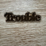 On A Whim Hats Trouble Wood-Tone Iron-On Patch