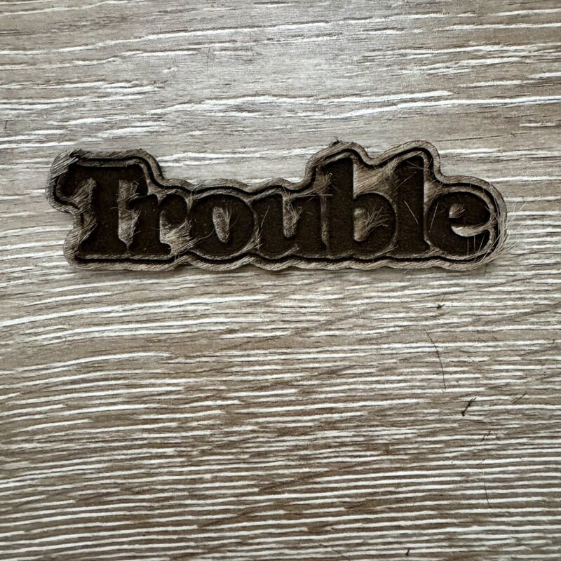 On A Whim Hats Trouble Wood-Tone Iron-On Patch