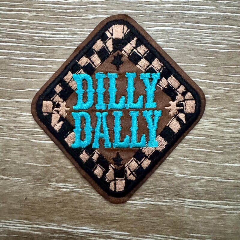 Dilly Dally iron-on patch on tan and black checkered diamond