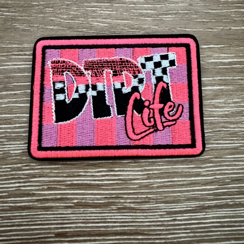 Dirt Life racing embroidered iron-on patch with checkered flag lettering and pink script
