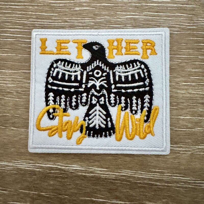 Let Her Stay Wild thunderbird iron-on patch in black and gold