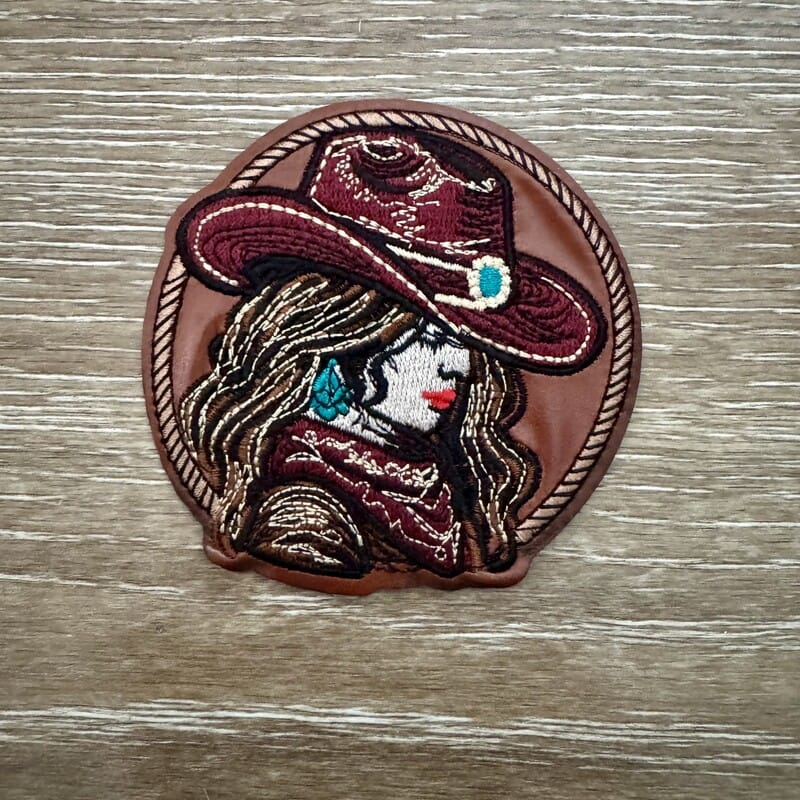 Maroon cowgirl portrait silhouette iron-on patch in circular design