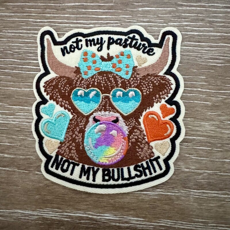Highland cow iron-on patch wearing heart sunglasses and bow tie