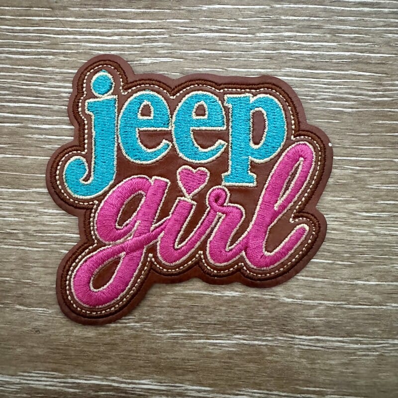 Off-Road Girl script iron-on patch on brown leather-look background