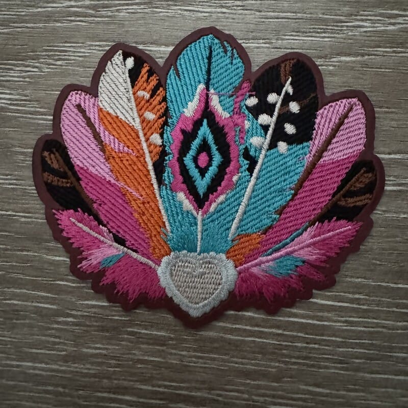 Pink and teal feather fan embroidered iron-on patch with a gray heart in hot pink, orange and turquoise by On A Whim Hats
