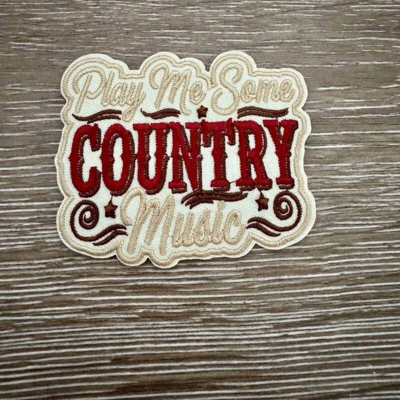 Play Me Some Country Music iron-on patch with red western lettering and script on cream badge