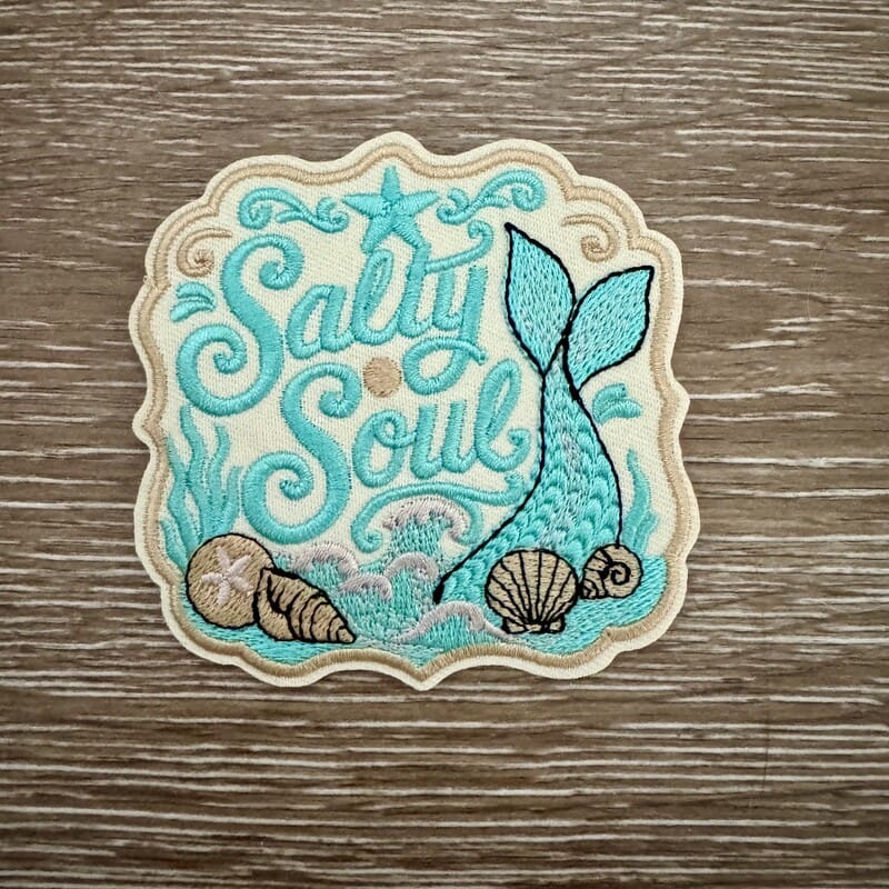 Salty Soul embroidered iron-on patch with teal mermaid tail, waves, shells and starfish