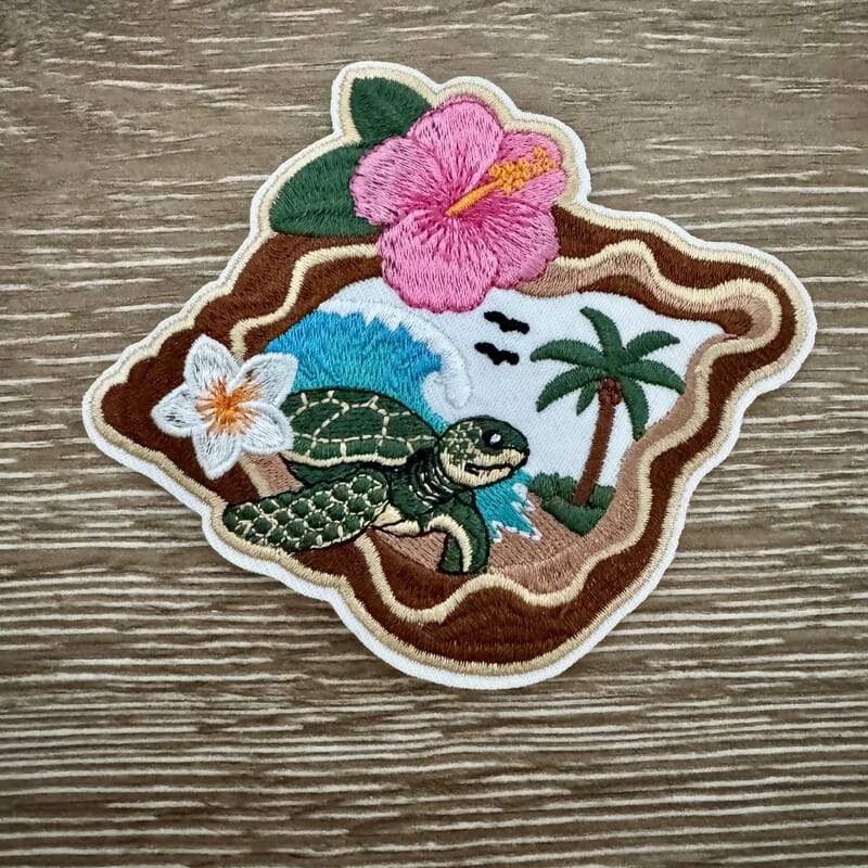 Sea turtle embroidered iron-on patch with pink hibiscus and palm trees for beach trucker hats
