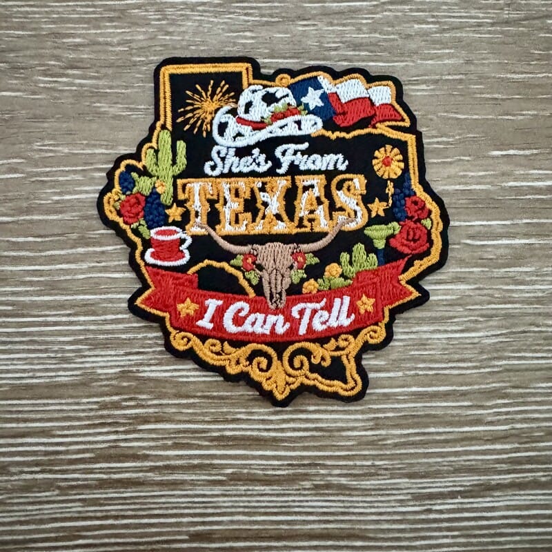 She's From Texas embroidered iron-on patch with Texas state, steer skull, cactus and flags