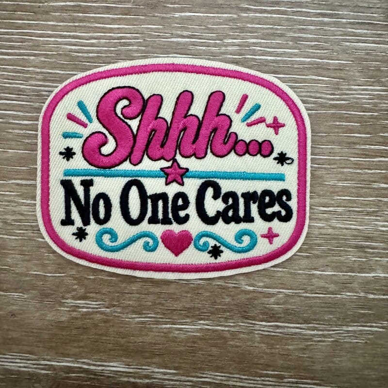 Shhh No One Cares sarcastic iron-on patch in hot pink and black