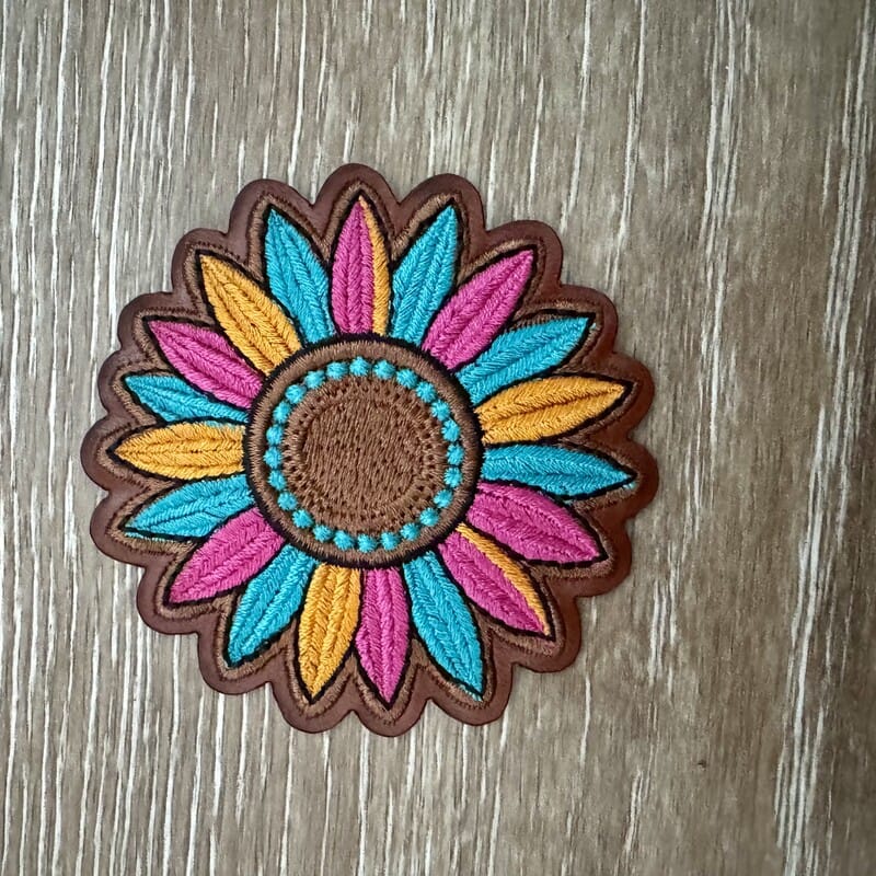 Teal and yellow sunflower iron-on patch with pink accents