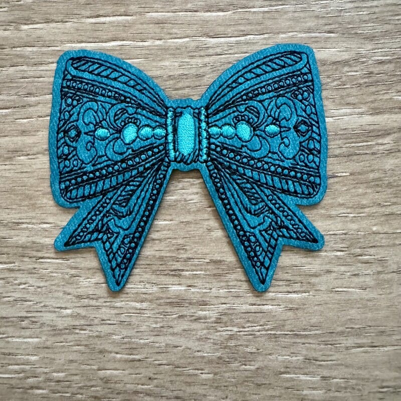 On A Whim Hats Teal Tooled Bow Iron-On Patch