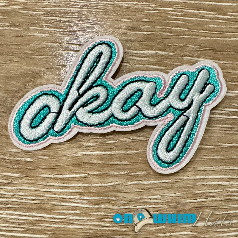 On A Whim Hats Okay Embroidered Iron-On Patch