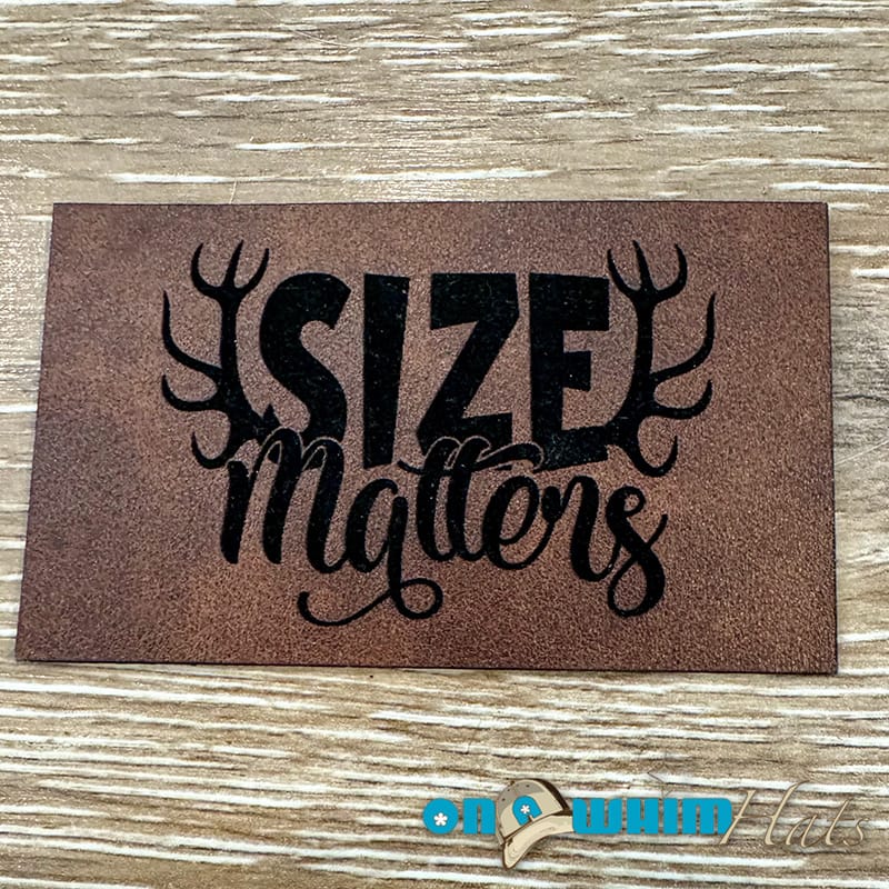 On A Whim Hats Size Matters Leatherette Iron-On Patch