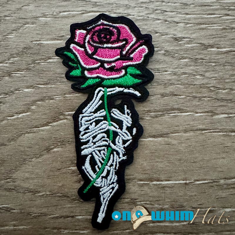 On A Whim Hats Skull Hand with Rose Iron-On Patch