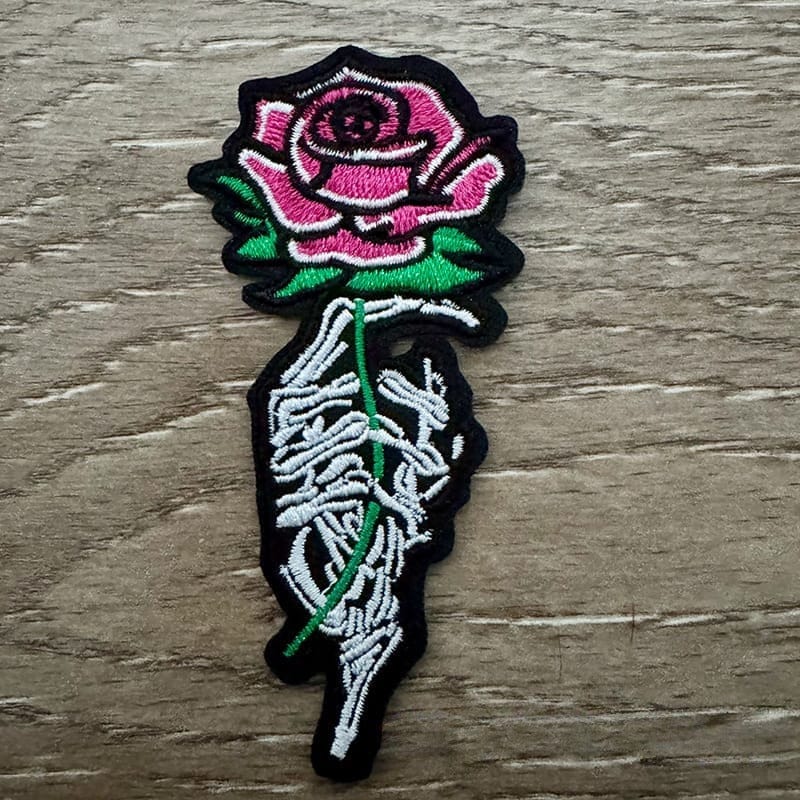 On A Whim Hats Skull Hand with Rose Iron-On Patch