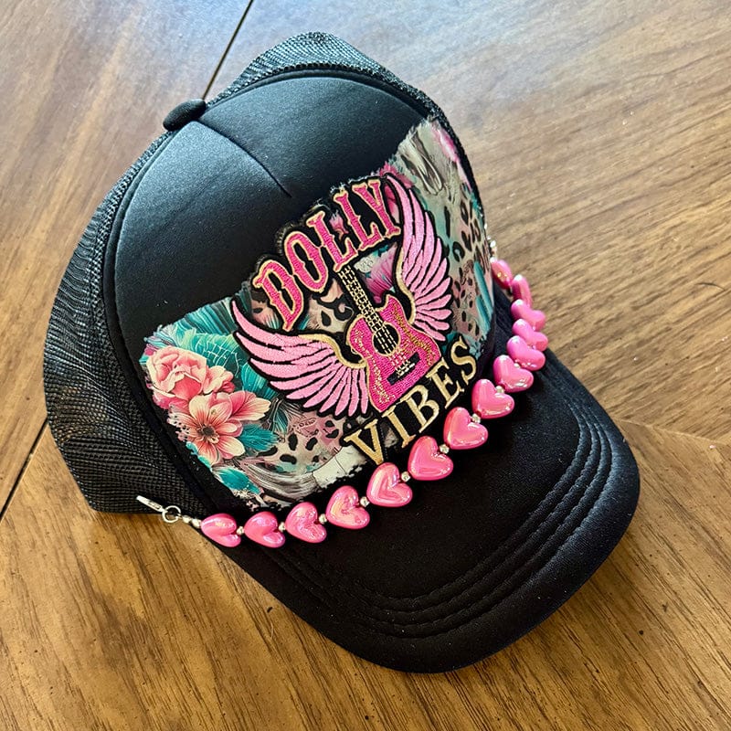 On A Whim Hats Dolly Vibes Trucker Hat - Black with Winged Guitar & Pink Heart Chain