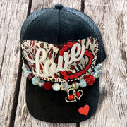 Black suede trucker hat with Love patch, red leopard tapestry and gold heart charm beaded chain by On A Whim Hats
