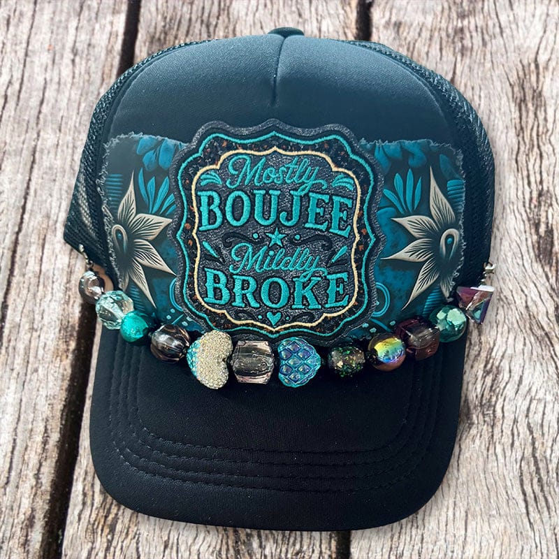 Black trucker hat with Mostly Boujee Mildly Broke patch, teal floral fabric and glass bead hat chain by On A Whim Hats